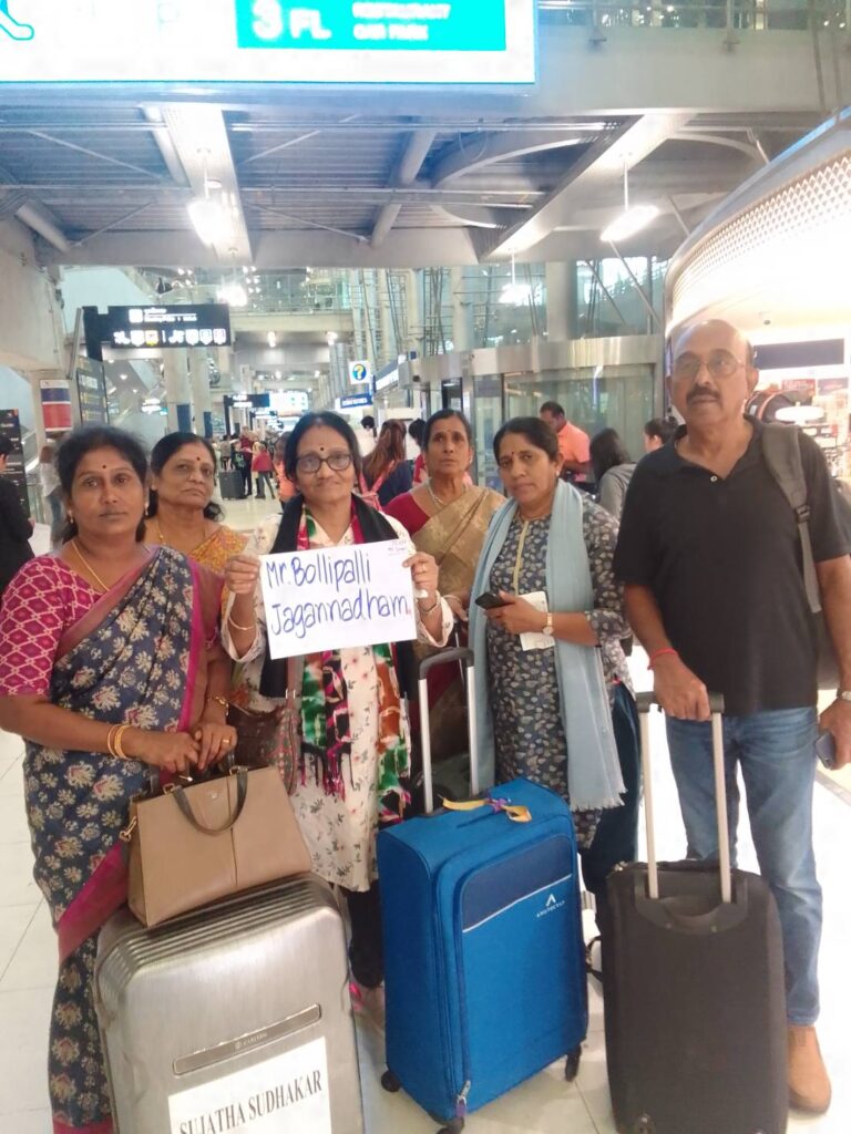 A family with their luggage, met by Orange Taxi at the airport