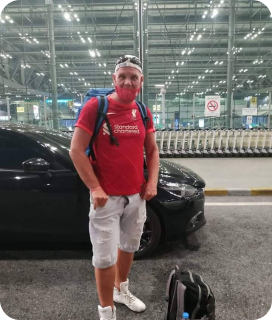 A customer with his bags next to the car